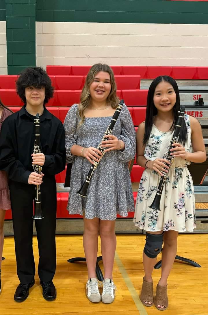 Three McCullough Junior High students pose with their clarinets after a band competition.