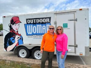Coach Venessa Wallace (left) and Coach Dawn Davis (right) with a trailer from Texas Parks and Wildlife’s Outdoor Woman program, one of many organizations they partner with for Peet Junior High’s Wildlife Management courses.